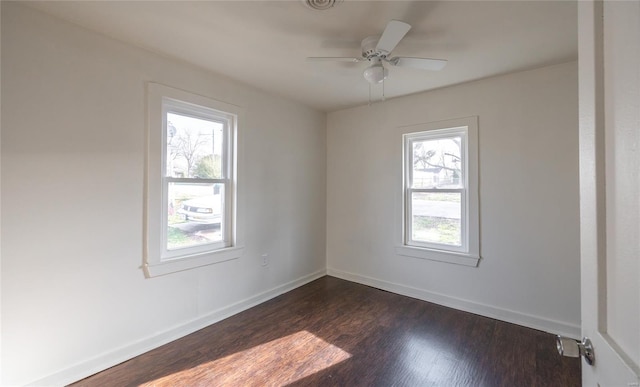 223 Warren St, Sullivan, MO 63080 - unfurnished room featuring healthy amount of natural light, dark wood-style floors, baseboards, and a ceiling fan