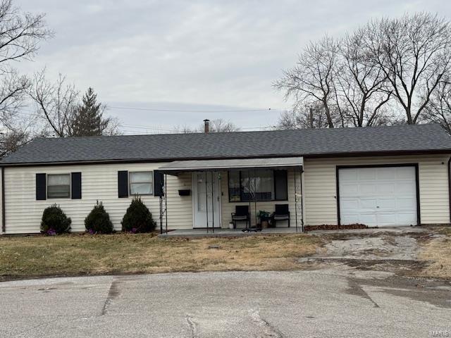 single story home with covered porch and an attached garage