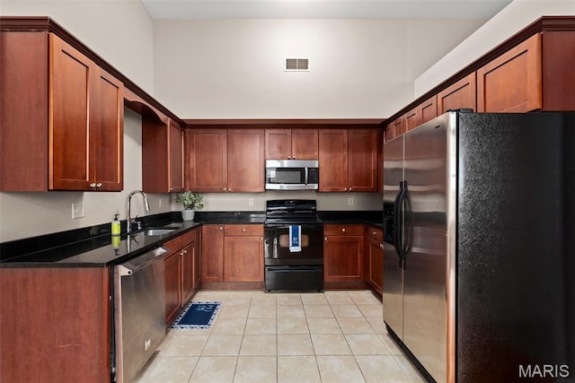 1515 Lafayette Ave Unit 316, Saint Louis, MO 63104 - kitchen with appliances with stainless steel finishes, a sink, light tile patterned flooring, and brown cabinets