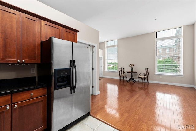 1515 Lafayette Ave Unit 316, Saint Louis, MO 63104 - kitchen with stainless steel fridge with ice dispenser, light wood finished floors, dark countertops, and baseboards