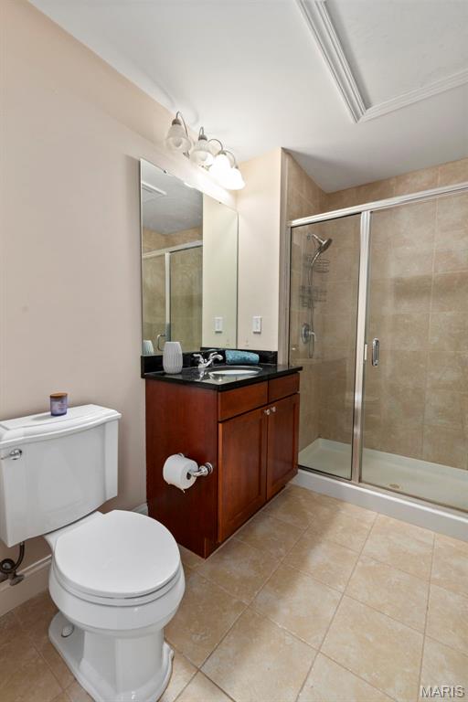1515 Lafayette Ave Unit 316, Saint Louis, MO 63104 - bathroom featuring tile patterned flooring, toilet, and a shower stall