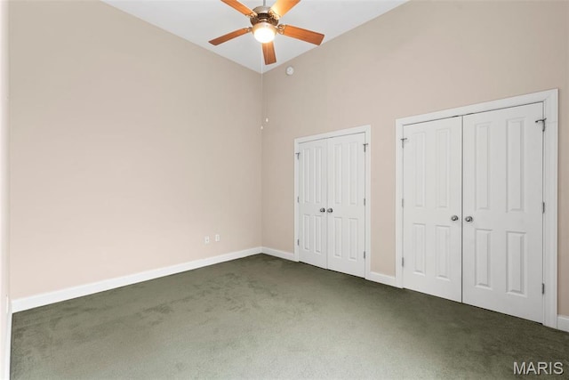 1515 Lafayette Ave Unit 316, Saint Louis, MO 63104 - unfurnished bedroom with dark colored carpet, two closets, baseboards, high vaulted ceiling, and a ceiling fan