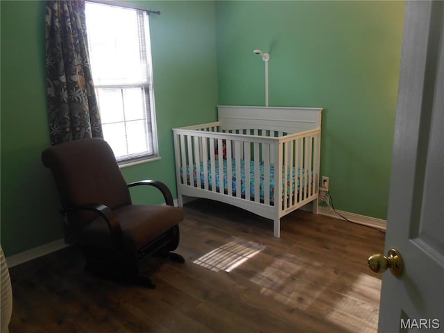 12954 Bryce Canyon Dr Unit E, Maryland Heights, MO 63043 - bedroom with wood finished floors, baseboards, and a nursery area