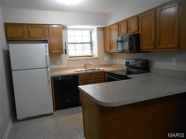 12954 Bryce Canyon Dr Unit E, Maryland Heights, MO 63043 - kitchen with black appliances, a peninsula, brown cabinetry, and light tile patterned flooring