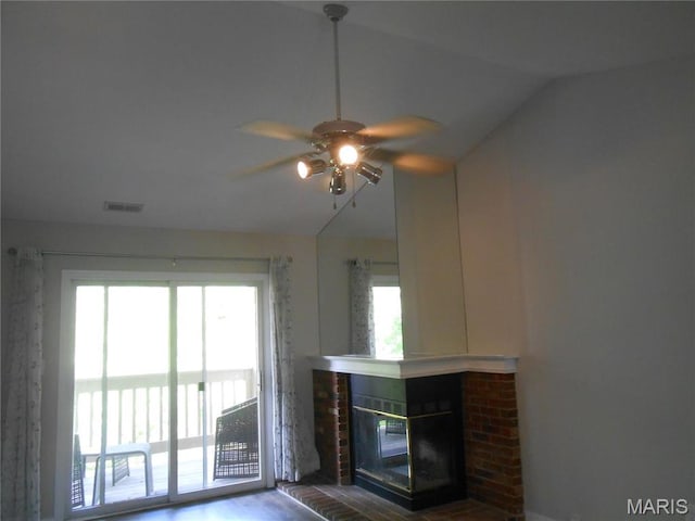 12954 Bryce Canyon Dr Unit E, Maryland Heights, MO 63043 - unfurnished living room with lofted ceiling, a ceiling fan, healthy amount of natural light, a brick fireplace, and wood finished floors