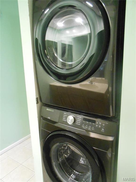 12954 Bryce Canyon Dr Unit E, Maryland Heights, MO 63043 - washroom with estacked washer and dryer and light tile patterned floors