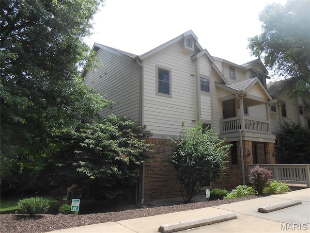 12954 Bryce Canyon Dr Unit E, Maryland Heights, MO 63043 - view of property exterior with brick siding and a balcony