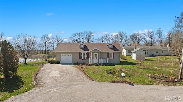 10 Mallard Dr, Carlyle, IL 62231 - ranch-style home featuring a garage, driveway, a front lawn, covered porch, and a water view