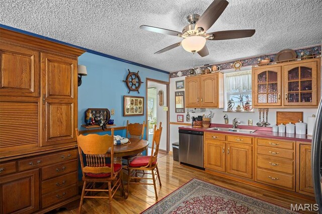 10 Mallard Dr, Carlyle, IL 62231 - kitchen featuring stainless steel dishwasher, a sink, a textured ceiling, light wood-style floors, and a ceiling fan