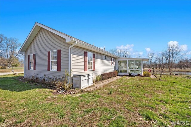 10 Mallard Dr, Carlyle, IL 62231 - view of side of property featuring a sunroom and a yard