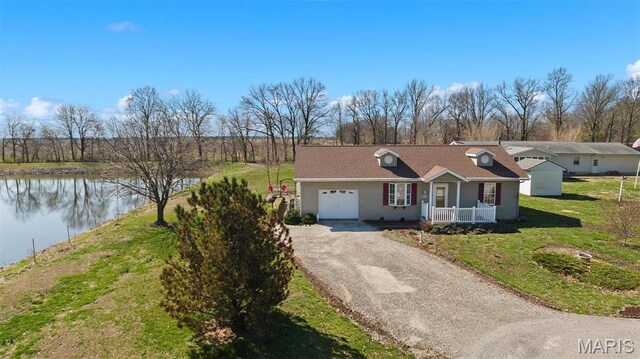 10 Mallard Dr, Carlyle, IL 62231 - ranch-style house with a water view, covered porch, a garage, driveway, and a front yard