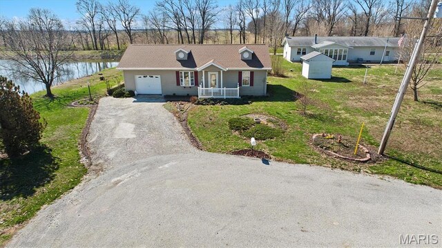 10 Mallard Dr, Carlyle, IL 62231 - ranch-style home with a garage, driveway, a front lawn, a water view, and a porch