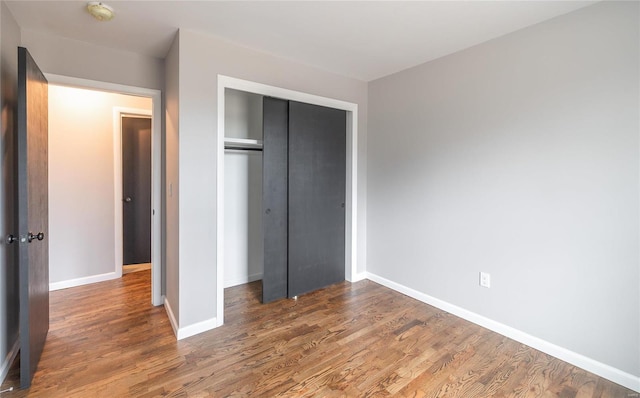12000 State Rte E, Rolla, MO 65401 - unfurnished bedroom featuring wood finished floors, baseboards, and a closet