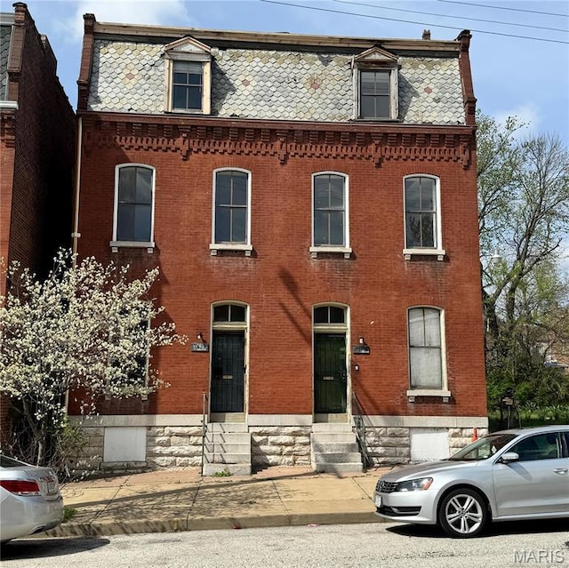 1519 Mallinckrodt St, Saint Louis, MO 63107 - victorian home with entry steps, mansard roof, brick siding, and a high end roof