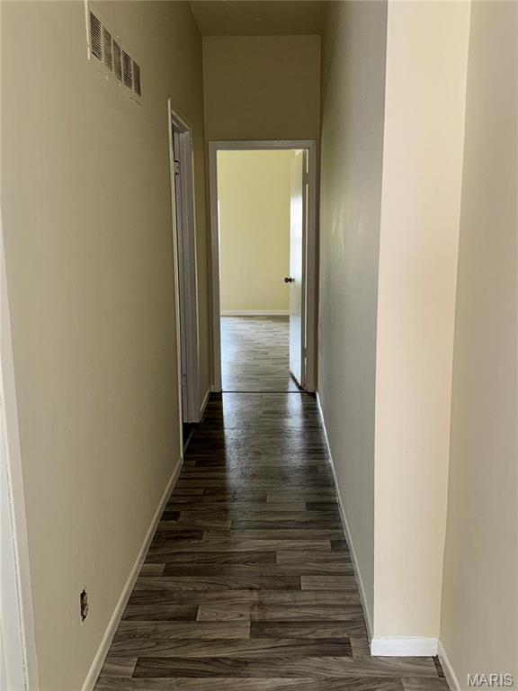 1519 Mallinckrodt St, Saint Louis, MO 63107 - corridor with dark wood-style floors and baseboards