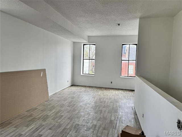 1519 Mallinckrodt St, Saint Louis, MO 63107 - spare room featuring wood finished floors and a textured ceiling