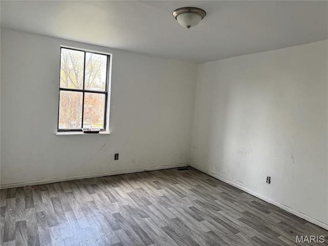 1519 Mallinckrodt St, Saint Louis, MO 63107 - empty room with wood finished floors and baseboards