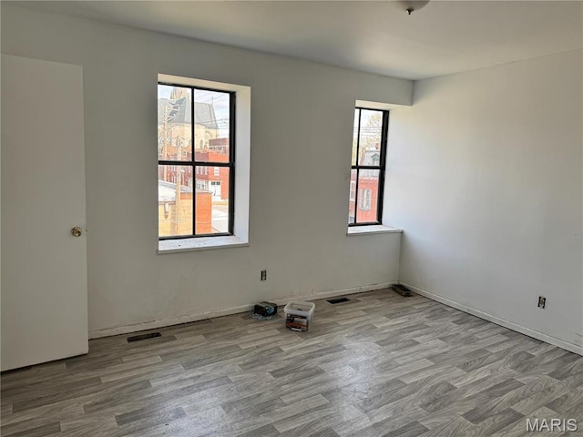 1519 Mallinckrodt St, Saint Louis, MO 63107 - spare room with wood finished floors and baseboards