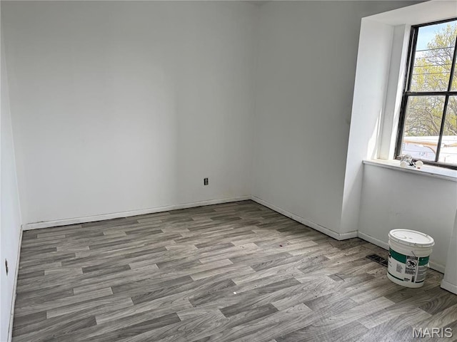 1519 Mallinckrodt St, Saint Louis, MO 63107 - spare room with wood finished floors and baseboards