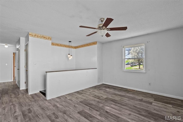 953 E 1st St, Washington, MO 63090 - unfurnished room featuring ceiling fan, a textured ceiling, wood finished floors, and baseboards