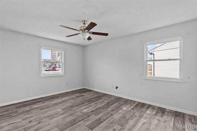 953 E 1st St, Washington, MO 63090 - spare room featuring wood finished floors, healthy amount of natural light, a textured ceiling, and ceiling fan