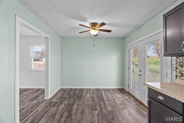 953 E 1st St, Washington, MO 63090 - unfurnished dining area with wood finished floors, ceiling fan, a textured ceiling, and baseboards