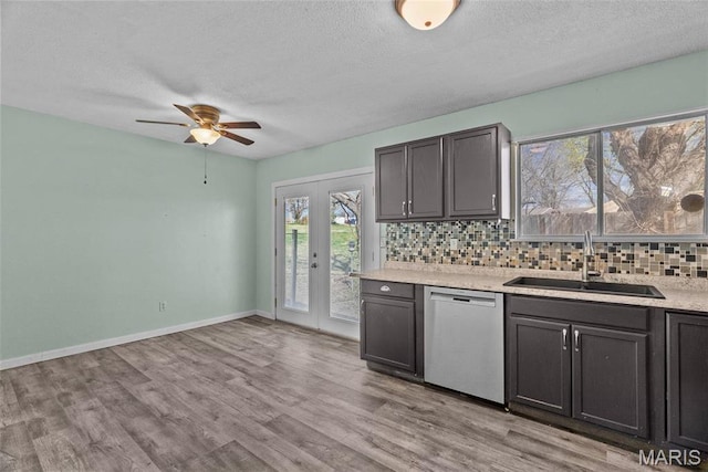 953 E 1st St, Washington, MO 63090 - kitchen with dishwasher, a sink, decorative backsplash, a ceiling fan, and a textured ceiling