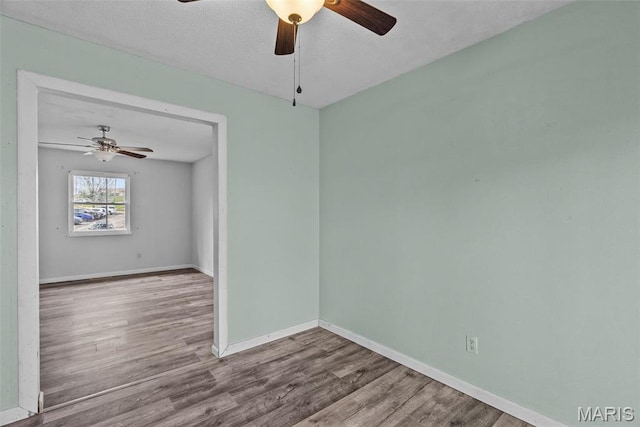 953 E 1st St, Washington, MO 63090 - empty room with ceiling fan, wood finished floors, baseboards, and a textured ceiling