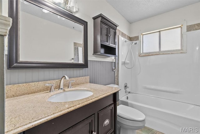 953 E 1st St, Washington, MO 63090 - bathroom with toilet, wainscoting, shower / washtub combination, a textured ceiling, and vanity