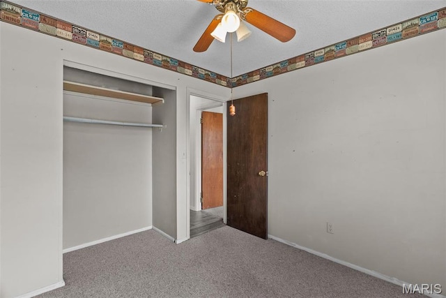 953 E 1st St, Washington, MO 63090 - unfurnished bedroom featuring carpet flooring, baseboards, a closet, a ceiling fan, and a textured ceiling