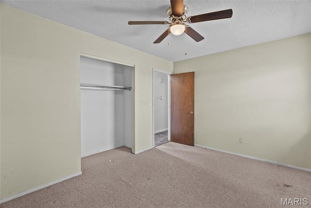 953 E 1st St, Washington, MO 63090 - unfurnished bedroom with carpet, a closet, a textured ceiling, baseboards, and a ceiling fan