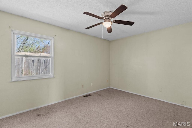 953 E 1st St, Washington, MO 63090 - empty room featuring carpet flooring, ceiling fan, baseboards, and a textured ceiling