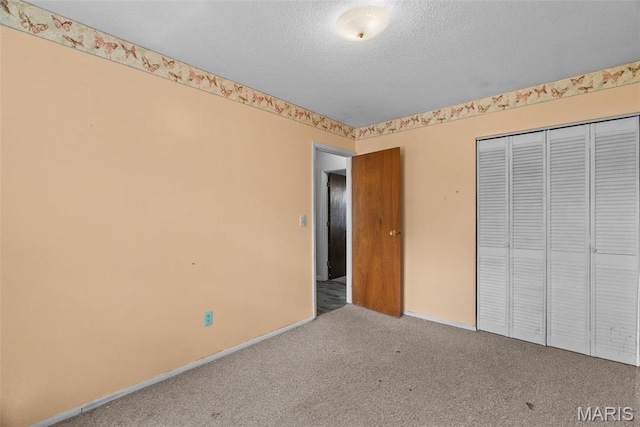953 E 1st St, Washington, MO 63090 - unfurnished bedroom featuring carpet, a closet, a textured ceiling, and baseboards