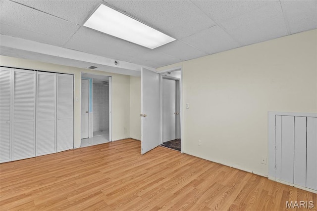 953 E 1st St, Washington, MO 63090 - unfurnished bedroom featuring light wood-type flooring, two closets, and a drop ceiling