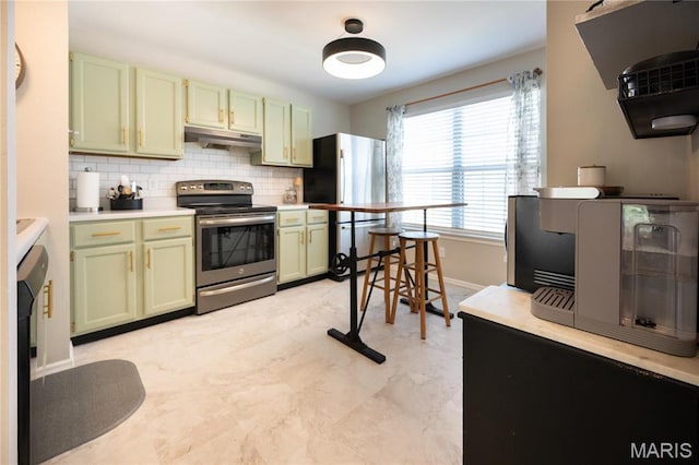 749 Sugar Glen Dr Unit 8, Saint Peters, MO 63376 - kitchen with green cabinetry, stainless steel appliances, under cabinet range hood, backsplash, and baseboards