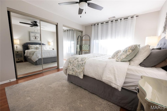 749 Sugar Glen Dr Unit 8, Saint Peters, MO 63376 - bedroom with two closets, wood finished floors, a ceiling fan, and baseboards