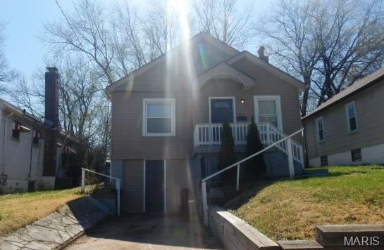 7122 Dawson Pl, Saint Louis, MO 63136 - view of front of house with a front yard, stairs, and a chimney