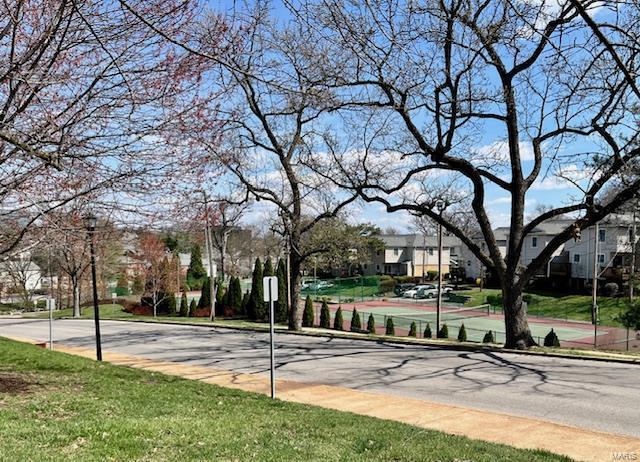 1767 High School Dr, Brentwood, MO 63144 - view of asphalt road with sidewalks, curbs, and traffic signs