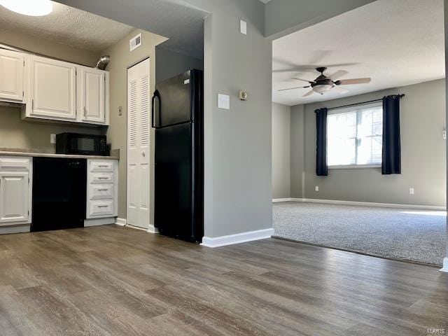 1767 High School Dr, Brentwood, MO 63144 - kitchen with black appliances, wood finished floors, baseboards, white cabinets, and ceiling fan