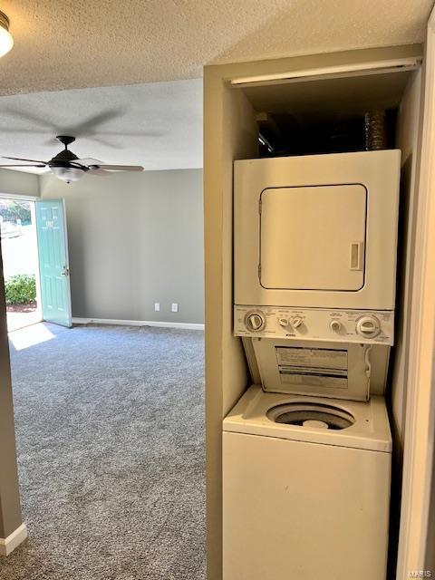 1767 High School Dr, Brentwood, MO 63144 - washroom with stacked washer / drying machine, carpet, a textured ceiling, and a ceiling fan