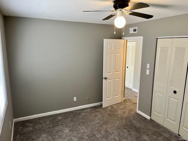 1767 High School Dr, Brentwood, MO 63144 - unfurnished bedroom featuring dark carpet, a closet, baseboards, and a ceiling fan