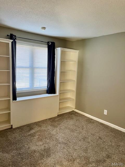 1767 High School Dr, Brentwood, MO 63144 - empty room with dark colored carpet, a textured ceiling, a smoke detector, and baseboards