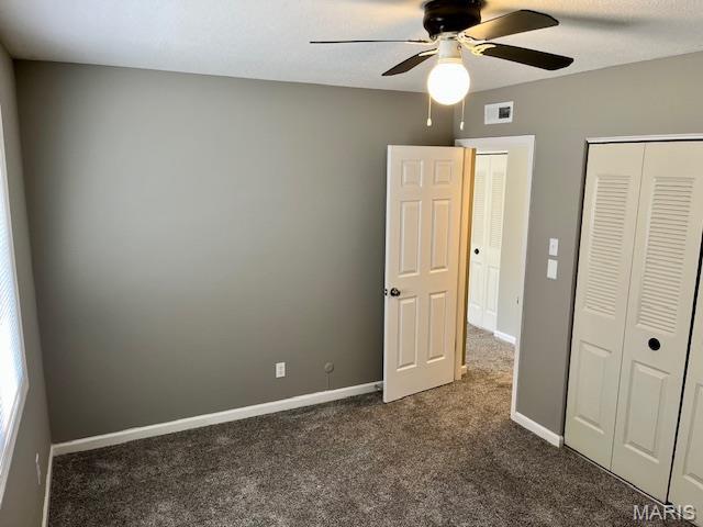 1767 High School Dr, Brentwood, MO 63144 - unfurnished bedroom featuring dark carpet, a closet, baseboards, and a ceiling fan