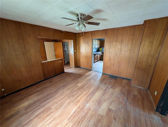 1300 Rixon, Alton, IL 62002 - spare room featuring ceiling fan, wood finished floors, and wooden walls