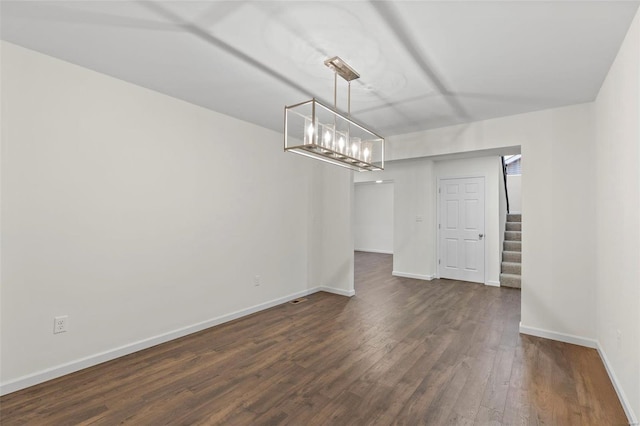 2414 Chukka Dr, Eureka, MO 63025 - unfurnished dining area with dark wood-type flooring, stairs, baseboards, and a chandelier