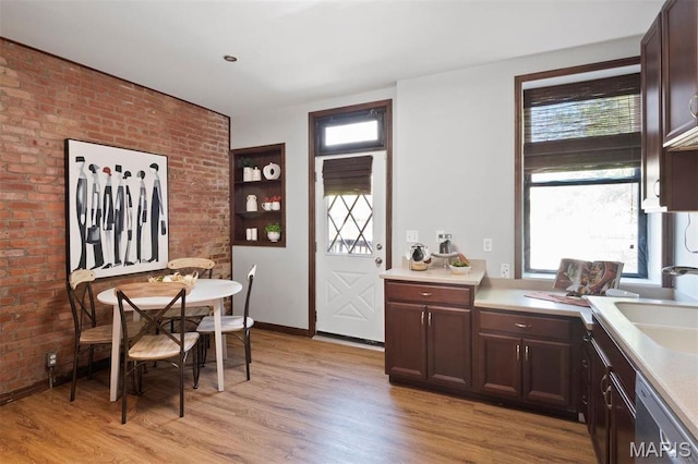 4525 Oakland Ave, Saint Louis, MO 63110 - kitchen with a sink, plenty of natural light, light countertops, and brick wall