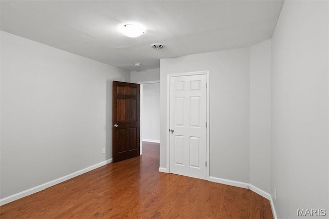 4525 Oakland Ave, Saint Louis, MO 63110 - spare room featuring wood finished floors and baseboards