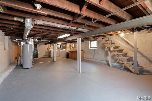 4525 Oakland Ave, Saint Louis, MO 63110 - below grade area featuring water heater, washer / dryer, and stairway