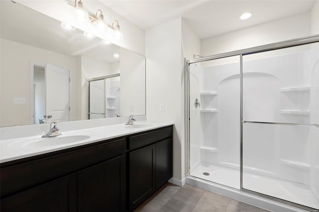 16787 River Stone Dr, Florissant, MO 63031 - bathroom with a stall shower, double vanity, and tile patterned flooring