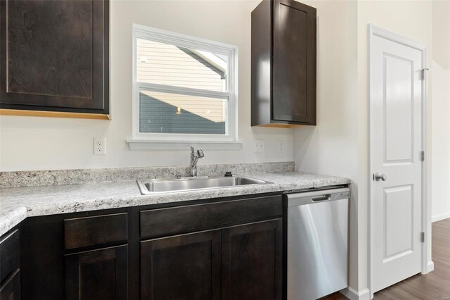 16787 River Stone Dr, Florissant, MO 63031 - kitchen featuring dishwasher, a sink, dark brown cabinets, and light countertops